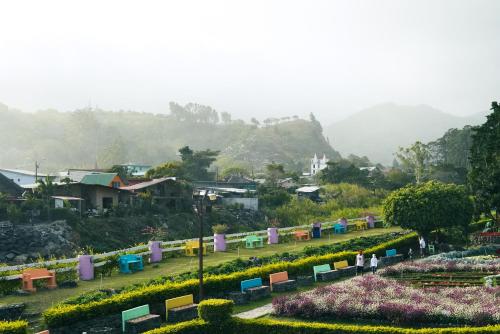 a park with colorful benches and flowers in a city at ONDA Boquete - En Desarrollo in Boquete