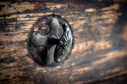 a metal door knob on a wooden door at Postschlössl in Lermoos