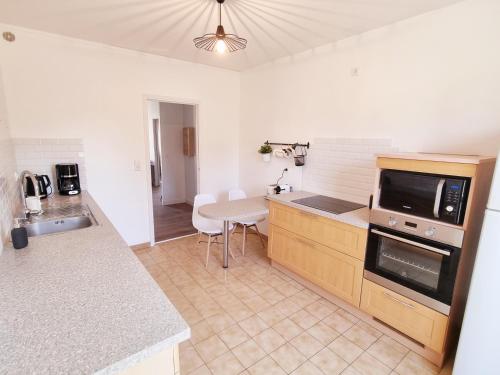 a kitchen with a table and a counter top at Bel appartement centre ville 3 chambres in Saint-Florent