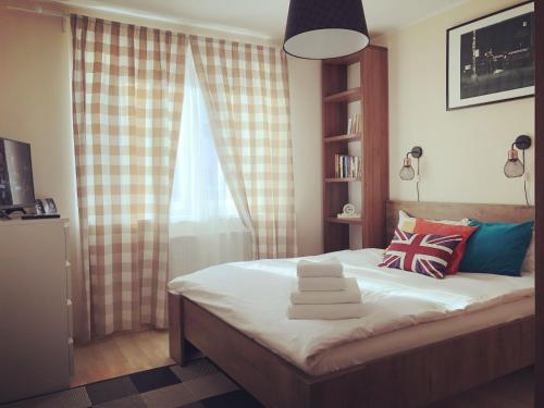 a small bedroom with a bed with a window at Belle View Apartment Brasov in Braşov