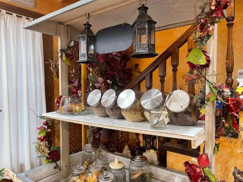 a shelf with bowls and other items on it at Hostal Vall D'Aneu by Arcas & Sambola in Esterri d'Àneu