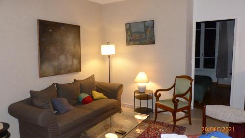 a living room with a couch and a chair at Suite 22 in Aix-les-Bains