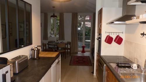 a kitchen with a counter and a dining room at Suite 22 in Aix-les-Bains