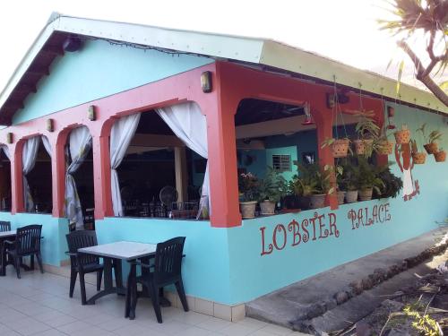 a restaurant with tables and chairs in front of it at Sunset Bay Club & SeaSide Resort in Salisbury