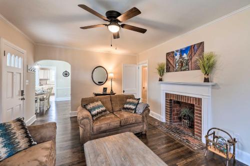 a living room with a couch and a fireplace at New Bern Retreat with Fire Pit about 1 Mi to Dtwn! in New Bern