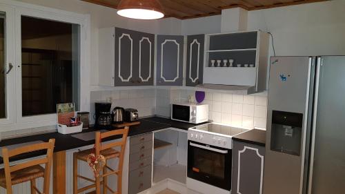 a kitchen with a stove and a refrigerator at The Friendly Moose in Övertorneå