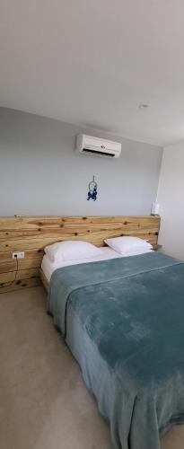 a bedroom with a bed with a wooden head board at Sunny Hill Apartment in Willemstad
