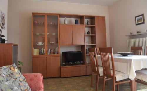 a living room with a table and a entertainment center at CASA CARLOTTA (Cipat 022104-AT-010301) in Levico Terme