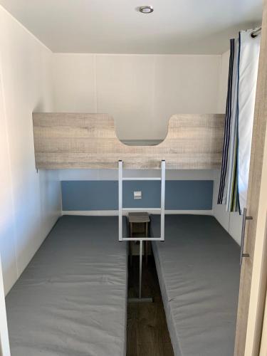 a bedroom with a bunk bed and a desk at Agriturismo Nonno Mario in Fossone dʼAdige
