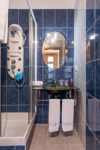 a bathroom with a shower and a sink and a mirror at Savana Apartment By Atlantic Holiday in Caniço