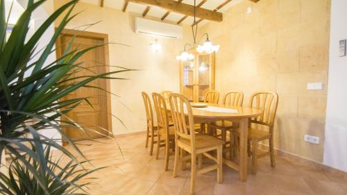 a dining room with a wooden table and chairs at Casa Maria by Sonne Villas in Ferreries