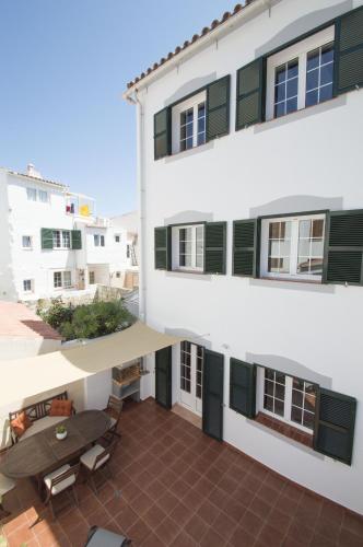 an apartment building with a patio and a table at Casa Maria by Sonne Villas in Ferreries