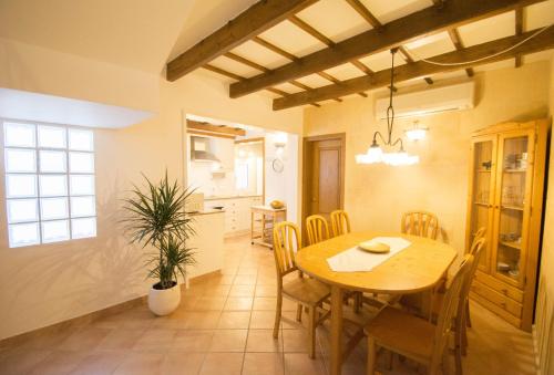 a kitchen and dining room with a table and chairs at Casa Maria by Sonne Villas in Ferreries