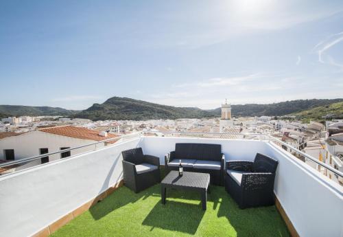 a balcony with chairs and a table and a view at Casa Maria by Sonne Villas in Ferreries