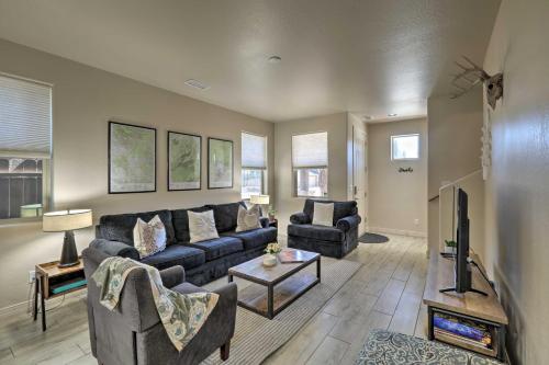 a living room with a couch and a tv at Centrally Located Flagstaff Vacation Home with Patio in Flagstaff