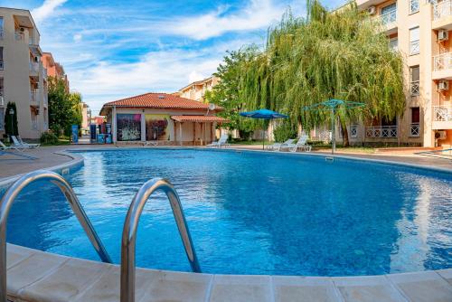 a large blue swimming pool with two buildings at Sunny Day 6 - Menada Apartments in Sunny Beach