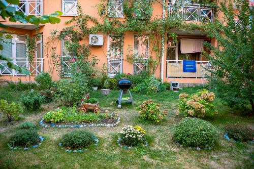 a garden with a grill in front of a house at Sunny Day 6 - Menada Apartments in Sunny Beach