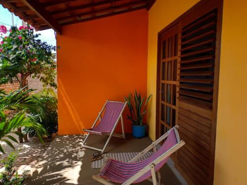 dos sillas sentadas en el porche de una casa en Chalé Pitanga, en São Miguel do Gostoso