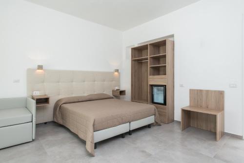 um quarto com uma cama e uma mesa de cabeceira e uma cama sidx sidx sidx em The Village Salento em Torre dell'Orso