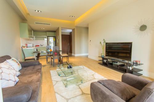a living room with a couch and a table at Accra Luxury Apartments @ Pearl in Accra