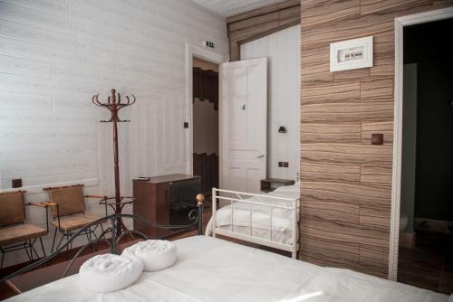 a bedroom with two beds in a room with wooden walls at 1920s Rooms in Kalamata