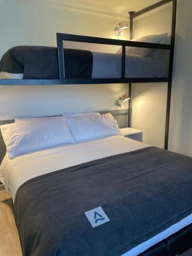 a bedroom with a bed with a bunk bed at Almasur Express Punta Arenas in Punta Arenas