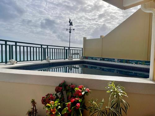 a swimming pool on the balcony of a building at White Sands Beach Condos in Christ Church