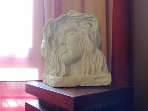 a statue of a woman sitting on a shelf at Hotel HamilTown in Cattolica
