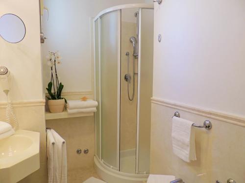 a bathroom with a shower and a sink at Hotel HamilTown in Cattolica