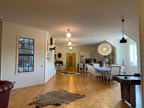 a living room with a table and a dining room at Bashults Gård in Jönköping