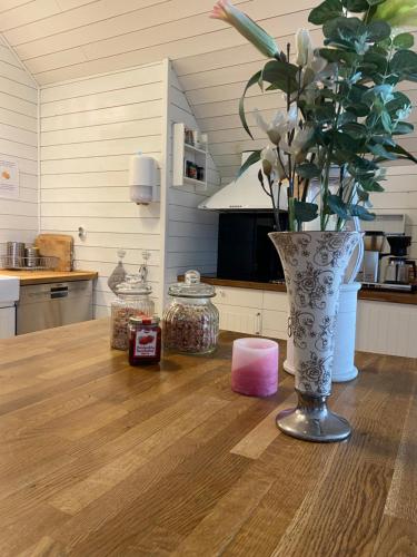 a vase with flowers on top of a wooden table at Bashults Gård in Jönköping