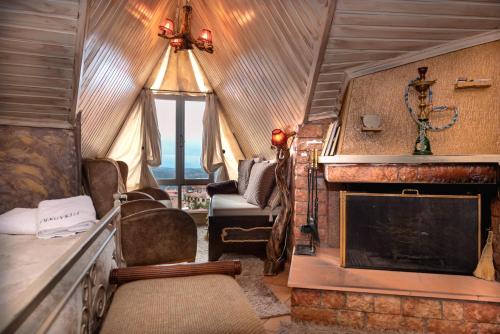 a living room with a fireplace in a train at Lykovrisi Guest House in Arachova