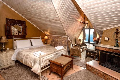 a bedroom with a bed and a fireplace at Lykovrisi Guest House in Arachova