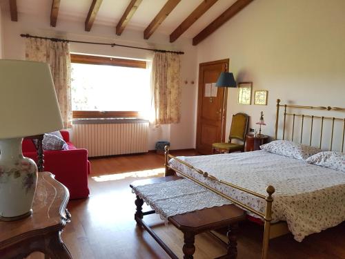 a bedroom with a bed and a window at B&B La Casaccia in Verbania