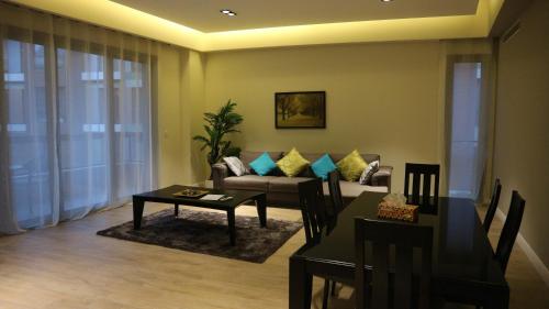 a living room with a couch and a table at Accra Luxury Apartments @ Pearl in Accra