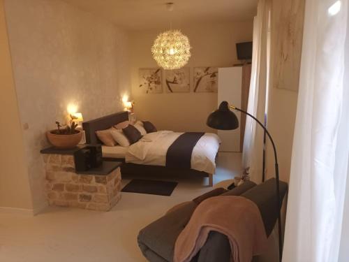a bedroom with a bed and a chandelier at Leut Apartment in Korčula