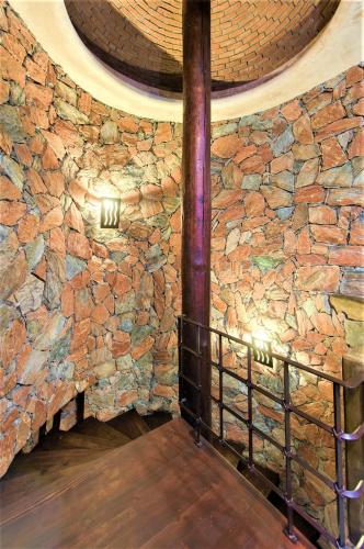 a stone wall in a room with a table at NEW Luxury Getaway - Pool, Spa, Sunset, VIEWS @ Casa Bella in Todos Santos