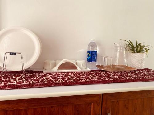 a counter top with a plate and a mirror on it at DOLPHIN ENCLAVE SERVICE STUDIO APARTMENTS in Kalpetta