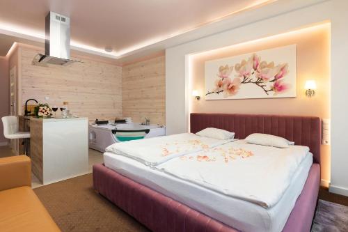 a bedroom with a large bed and a bathroom at Luna De Luxe Apartment in Michałowice