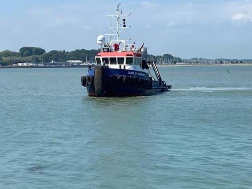 a blue and white boat in the water at Seaview B&B in Harwich