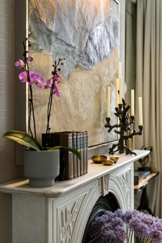 a console table with candles and flowers on it at The Adria in London