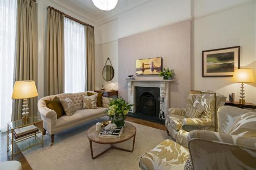 a living room with two couches and a fireplace at The Adria in London