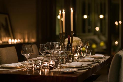 a long table with wine glasses and candles on it at The Adria in London