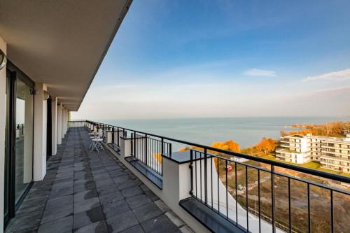 a balcony with a view of the ocean at MF Lux Penthouse in Siófok
