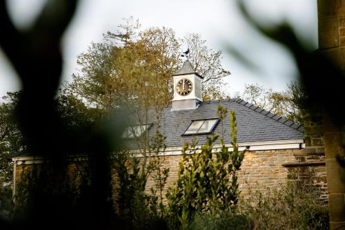 a building with a clock tower on top of it at Lanelay Hall Hotel & Spa in Hensol