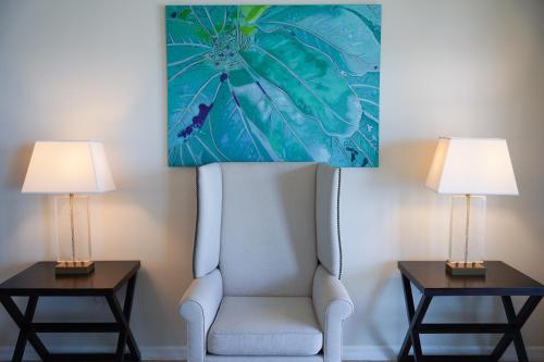 a chair and two lamps in a hotel room at Holiday Inn Resort Grand Cayman by IHG in George Town