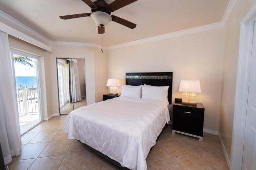 a bedroom with a bed and a ceiling fan at Holiday Inn Resort Grand Cayman by IHG in George Town