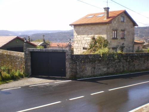 a garage in front of a house on a street at Casa Camino Santiago-Fisterra in Amés
