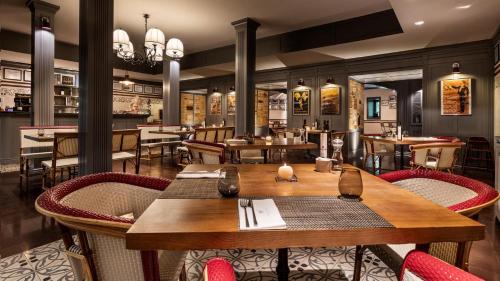 a restaurant with a wooden table and chairs at Vidago Palace in Vidago