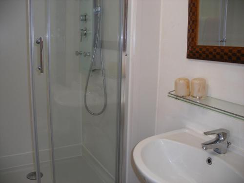 a bathroom with a shower and a sink at Hôtel Modern in Concarneau